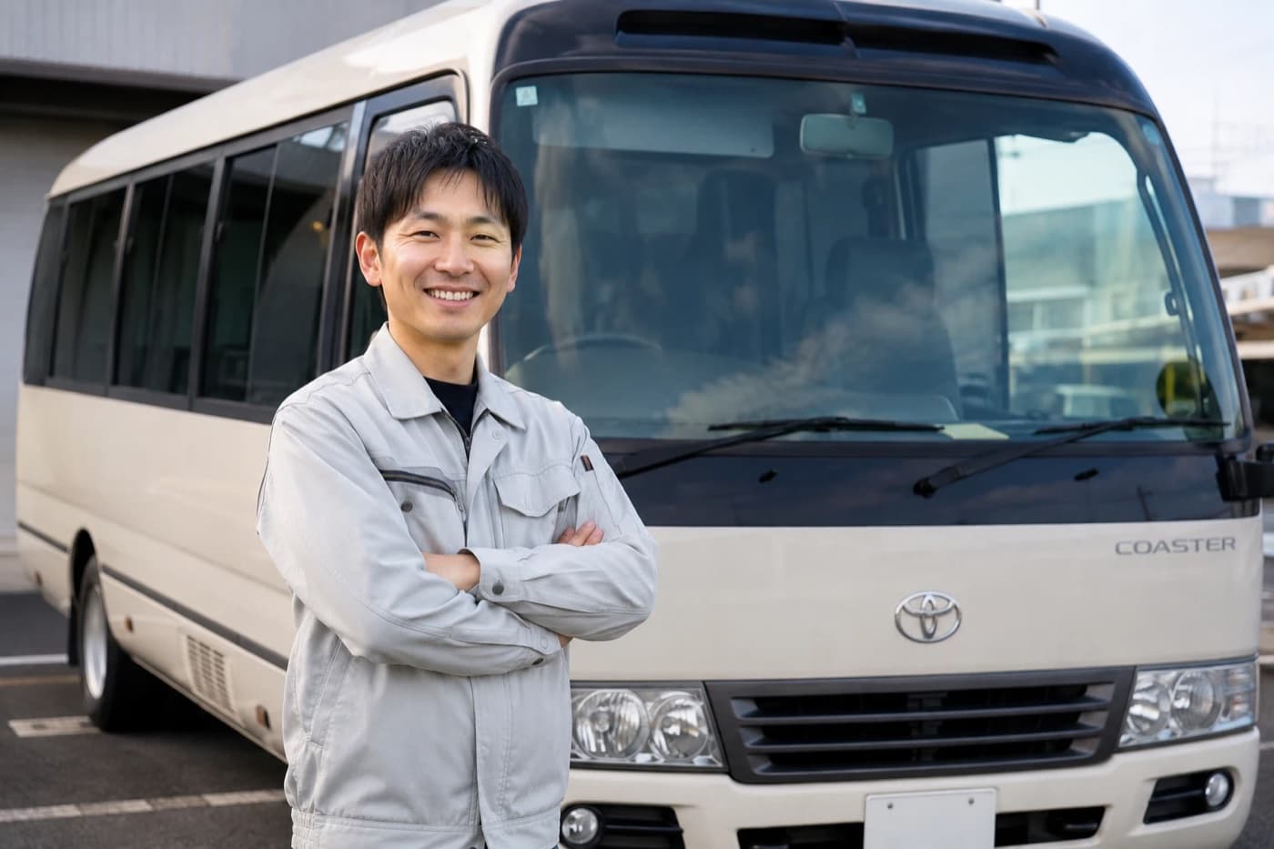 送迎バスの前に立つドライバーのイメージ